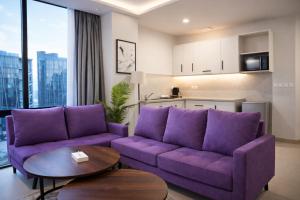 a living room with a purple couch and a table at Serene Comfort Suites in Rawalpindi