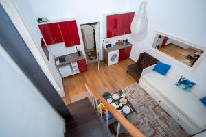 an overhead view of a living room and kitchen with red cabinets at Large 1-Bedroom 1 Doble bed 1 Sofa bed 1 Bathroom Duplex Apartment Prime Lisbon Location in Lisbon