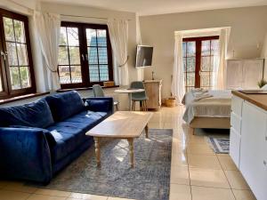 a living room with a blue couch and a table at H2O in Pobierowo