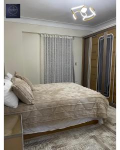 a bedroom with a large bed and a mirror at Half Moon Apartaments in Alexandria