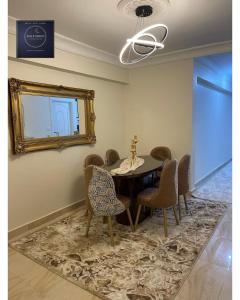 a dining room with a table and chairs and a mirror at Half Moon Apartaments in Alexandria +15 photos
