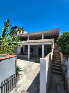 a house with stairs leading up to it at Casa com piscina e área gourmet próximo à praia com quarto suíte privativo in Saquarema