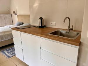 a kitchen with a sink next to a bed at H2O in Pobierowo +46 photos