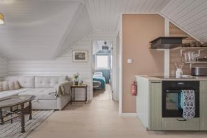 a living room with a couch and a kitchen at The Nordic Loft in Bergen +17 photos