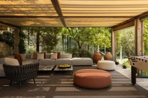 a patio with a couch and a table and a pool table at Rose Bank in Johannesburg