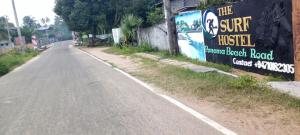 an empty street with a sign on the side of the road at The surf hostel in Panama