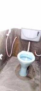 a bathroom with a toilet with a water hose at The surf hostel in Panama