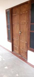a pair of wooden doors in a building at The surf hostel in Panama
