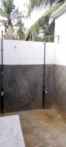 a concrete fence with a white wall and palm trees at The surf hostel in Panama
