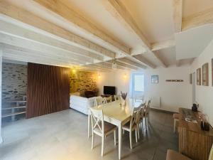 a dining room with a table and chairs and a bedroom at Villa Bella & Spa in Mouilleron-le-Captif