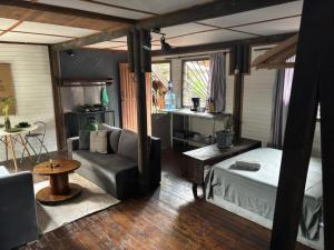 a room with a bed and a couch and a table at Casa Juntos by Villa Eden in Palomino
