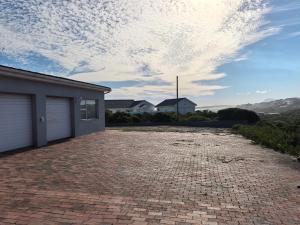 a brick driveway in front of a house at The Lookout in Pearly Beach