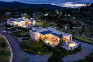 an aerial view of a large white house at night at The Peak Hill Pool Villa in Ban Wa Kachieo