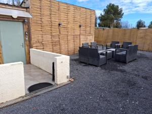 a group of chairs sitting next to a fence at La jonquiere etablisement climatisé in Landouzy-la-Cour +3 photos