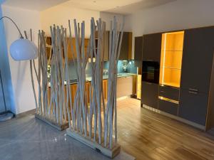 a kitchen with wooden sticks in a room at Appartement et spa in Douai
