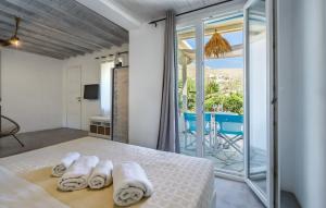 a bedroom with a bed with towels on it at Bella Alba in Kalafatis