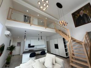 a living room with a staircase and a couch at Appartement et spa in Douai