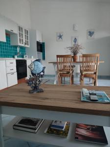 a kitchen and dining room with a table and chairs at Villetta bifamiliare con vista mare "Poggio Tavolara" in Porto San Paolo