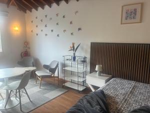 a bedroom with a bed and a table and chairs at Casa da Isabelinha in Ponta Delgada +31 photos