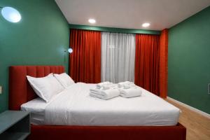 a bedroom with a bed with towels on it at Premium New Gudauri Apartments with Balcony & Gondola Views in Gudauri +8 photos