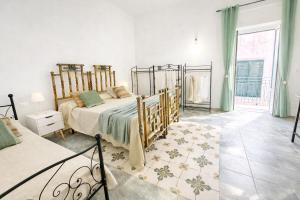 a bedroom with a bed and a large window at Maridea - Il Balcone sulla Storia in Ponza