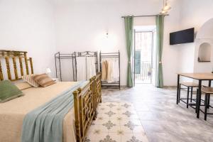 a bedroom with two beds and a table and a table at Maridea - Il Balcone sulla Storia in Ponza