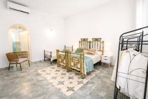 a bedroom with a bed and a chair at Maridea - Il Balcone sulla Storia in Ponza