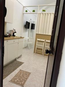 a kitchen with white cabinets and a counter top at Little house in Vasto +6 photos
