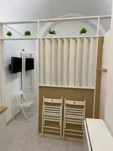 a room with two chairs and a white partition at Little house in Vasto