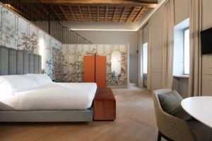 a bedroom with a bed and a table and chairs at Villa Clementi Boutique Hotel in Cave +35 photos