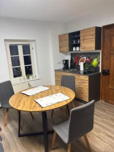 a kitchen with a wooden table and chairs in a kitchen at Forsthaus Neudorf - Eschenblick in Harzgerode