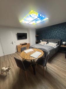a bedroom with a bed and a table with a dining room at Forsthaus Neudorf - Eschenblick in Harzgerode