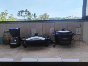 two pots and pans sitting on a counter with a window at Matapalo Hosting in Savegre +29 photos