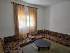 a living room with a couch and a table at بيت اطلالة الوادي in Ajloun