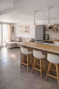 a kitchen and living room with a counter and chairs at Loft with Private Pool in Alzira in Alzira