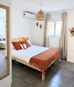 a bedroom with a bed with orange pillows at Loft with Private Pool in Alzira in Alzira