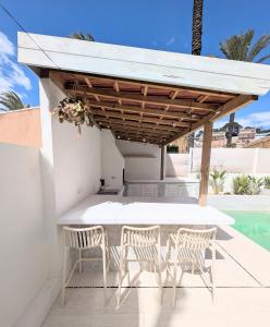 a patio with a table and chairs under a pavilion at Loft with Private Pool in Alzira in Alzira