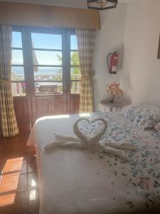 a bedroom with a bed with a heart on it at Taburiente in Tijarafe +68 photos