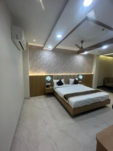 a bedroom with a large bed in a room at Hotel Vardaan Inn in Lucknow