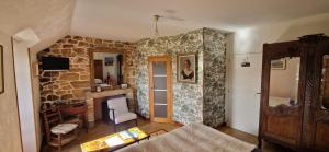 a living room with a stone wall at Auberge De Bel Air in Brélès