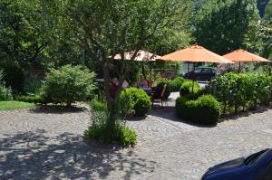 a patio with umbrellas and a table and chairs at Schöne Aussicht in Ediger-Eller