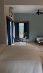a bedroom with a bed and a table and a chair at Mega Suite en Hotel Cosmos in Tamasopo