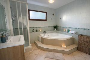 a large bathroom with a tub and a sink at La caza papangues in Sainte-Suzanne +18 photos