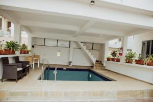 a swimming pool in a building with plants at Olive apartment in Maiyegun