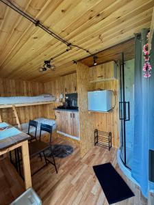 a kitchen and dining room in a log cabin at Tiny House by the river in Litoměřice