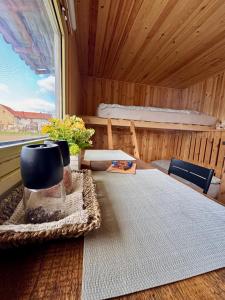 a room with a table in a sauna with a window at Tiny House by the river in Litoměřice