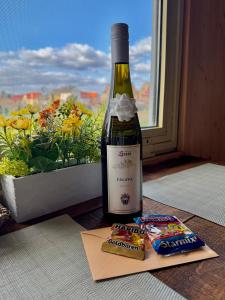 a bottle of wine and some snacks next to a window at Tiny House by the river in Litoměřice