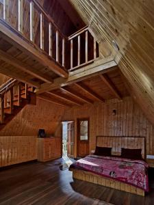 a bedroom with a bed in a wooden building at Jibhi Emberwood in Jibhi
