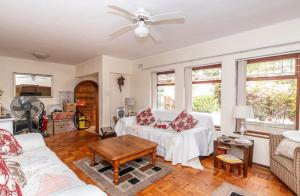a living room with a couch and a ceiling fan at Sunset Nest in Meadowridge
