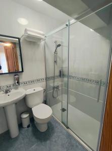 a bathroom with a shower and a toilet and a sink at Hostal Betelu in Betelu